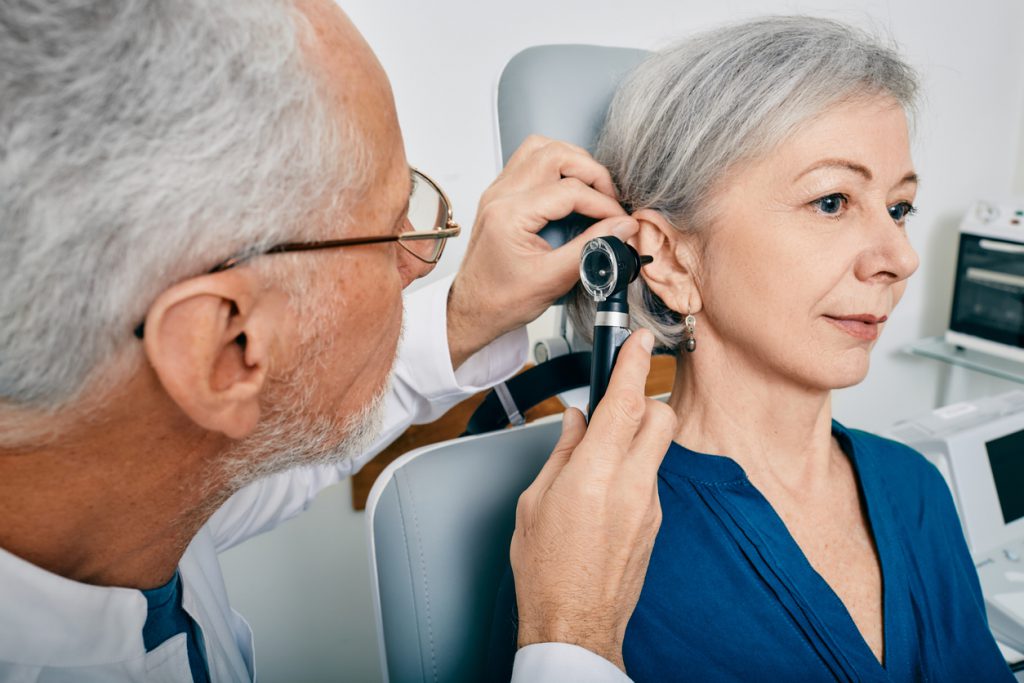 Otolaryngologist Doctor Checking Senior Woman's Ear Using Otoscope Or Auriscope At Medical Center. Hearing Test For Older People, Otoscopy